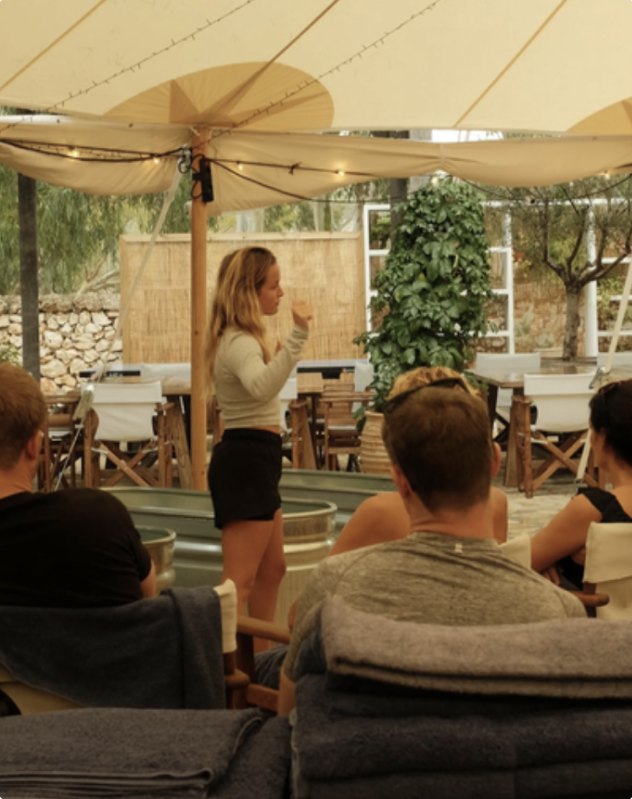 Tamara speaking to a group at an outdoor workshop