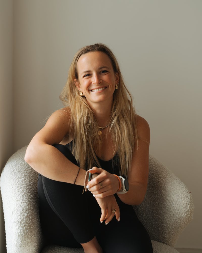 Tamara Harnett smiling, seated in an armchair